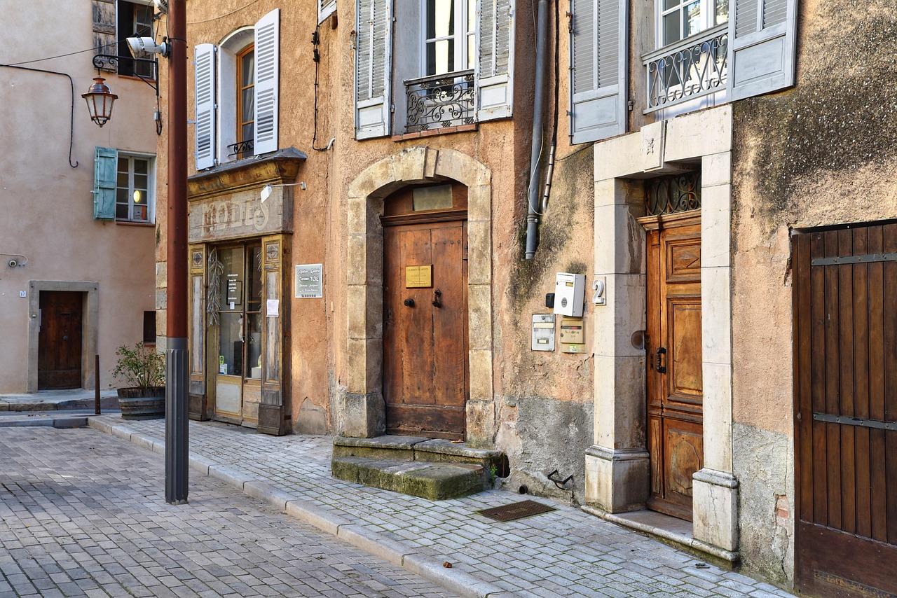Häuserzeile in einer französischen Altstadt mit Fensterläden, Haustüren und Briefkästen